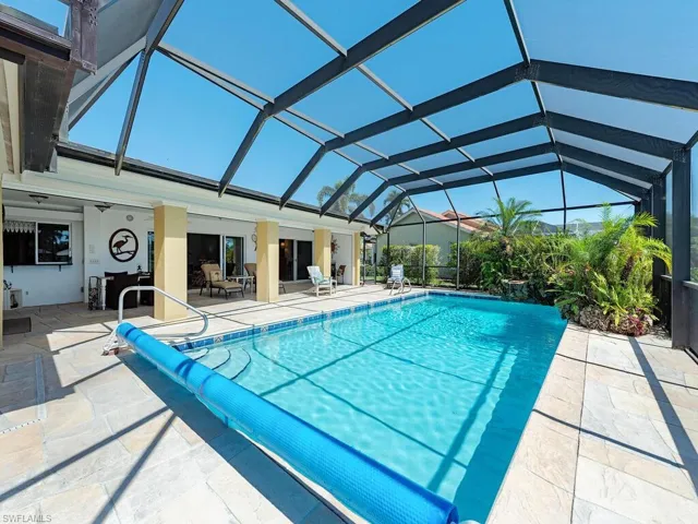 Outdoor pool with a lanai and a patio