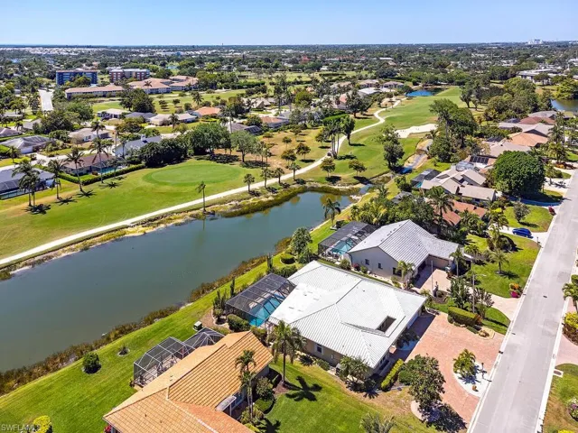 Birds eye view of property with a water view, view of golf course, and a residential view