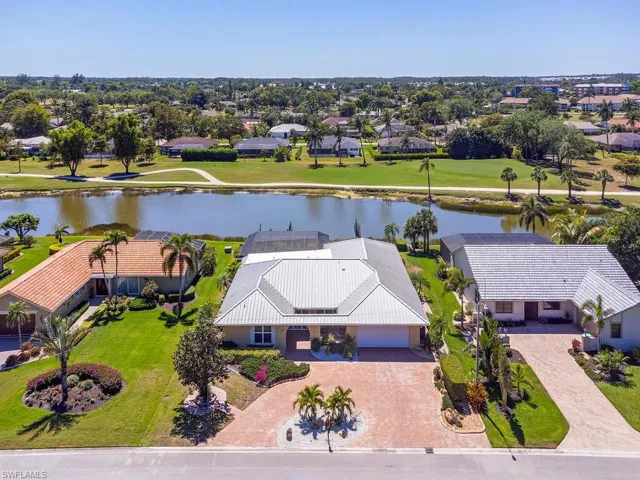 Drone / aerial view with a residential view and a water view