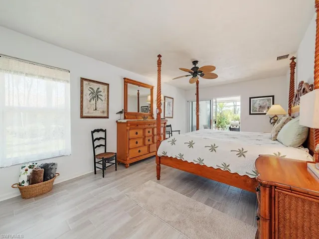 Bedroom with visible vents, ceiling fan, and light wood-style flooring