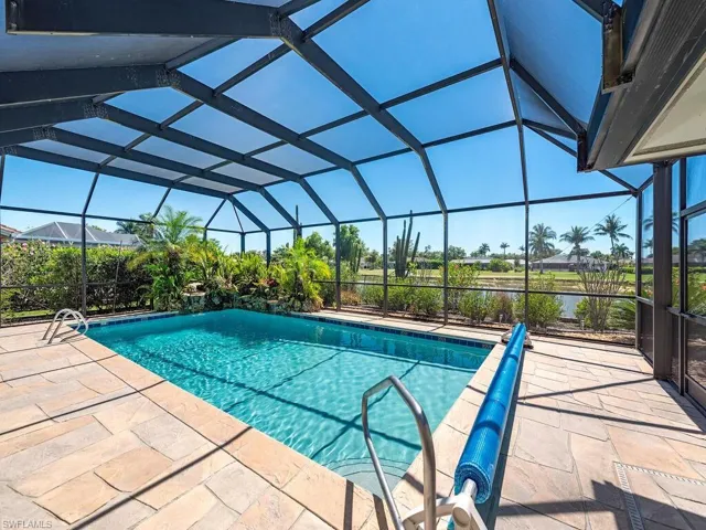 Pool with a patio and glass enclosure