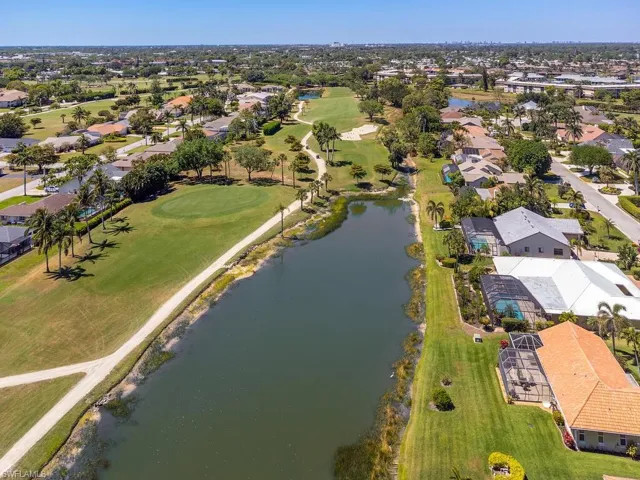 Birds eye view of property with a residential view, golf course view, and a water view