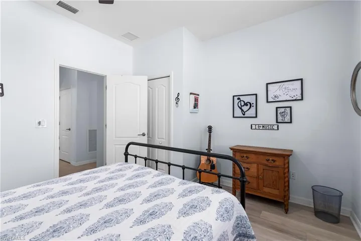 Bedroom with light wood finished floors and baseboards