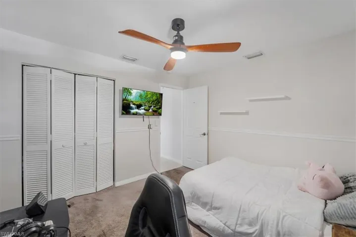 Second Bedroom featuring carpet floors, a closet, and ceiling fan