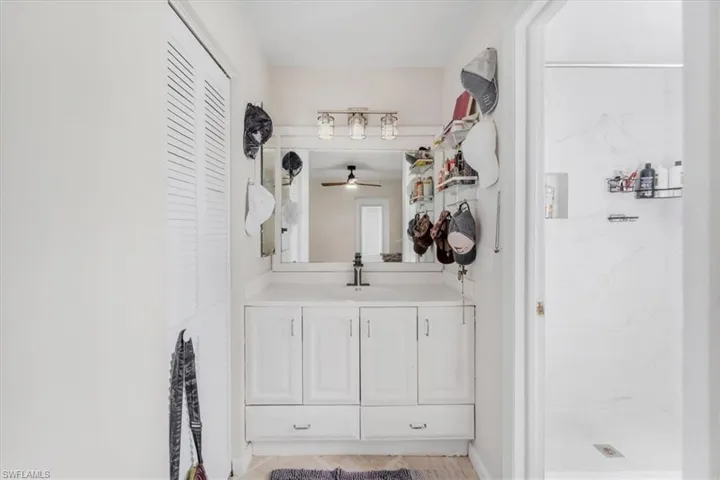 Bathroom with a shower, vanity, and ceiling fan