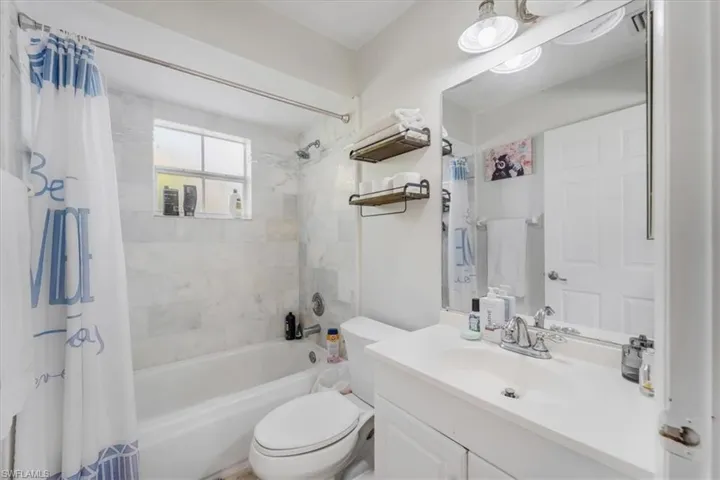 Full bathroom featuring vanity, toilet, and shower / tub combo