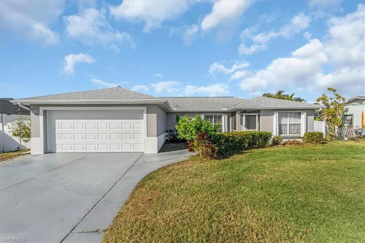 Single story home featuring a front yard and a 2 car garage