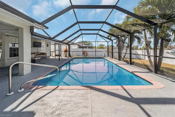 View of pool with an outdoor living space, a lanai, and a patio