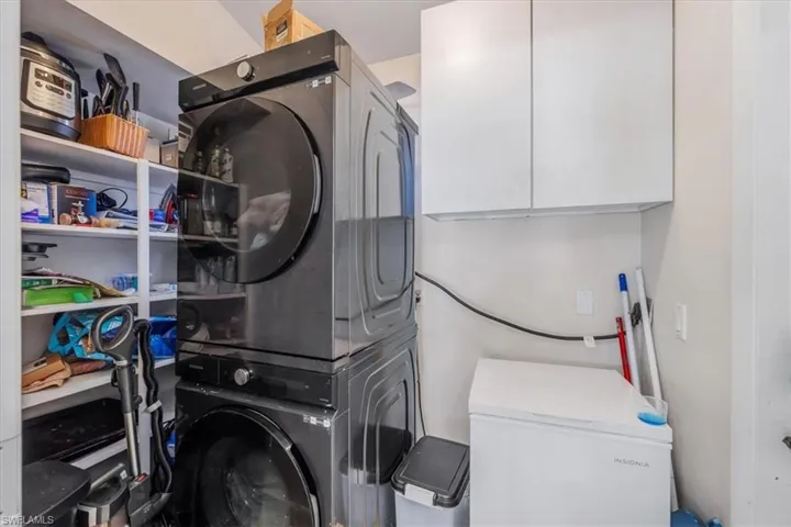 Laundry room featuring stacked washer and dryer