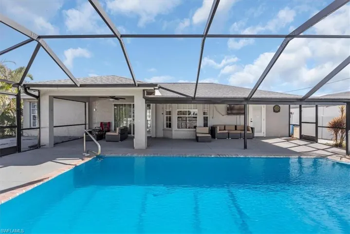 View of swimming pool with a lanai, ceiling fan, a patio, and an outdoor hangout area