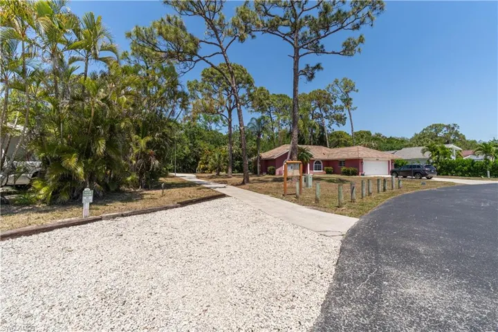 View of front of home with a garage and driveway