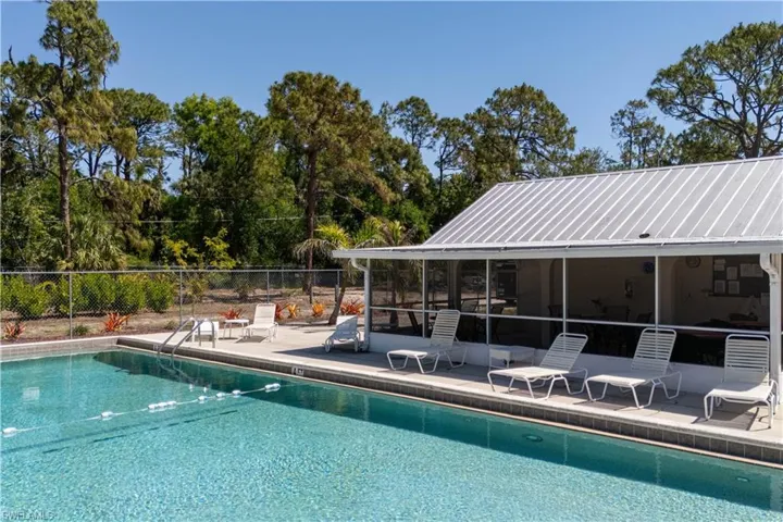 Pool with a patio, a sunroom, and fence
