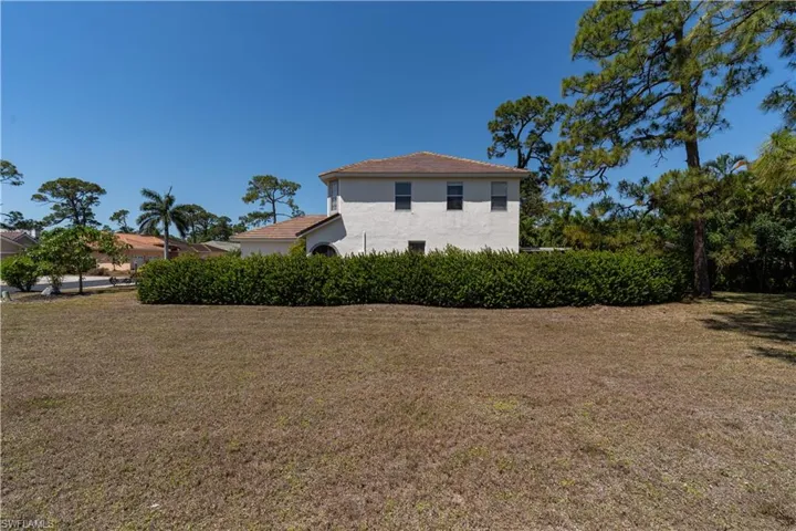 View of property exterior featuring a yard and stucco siding