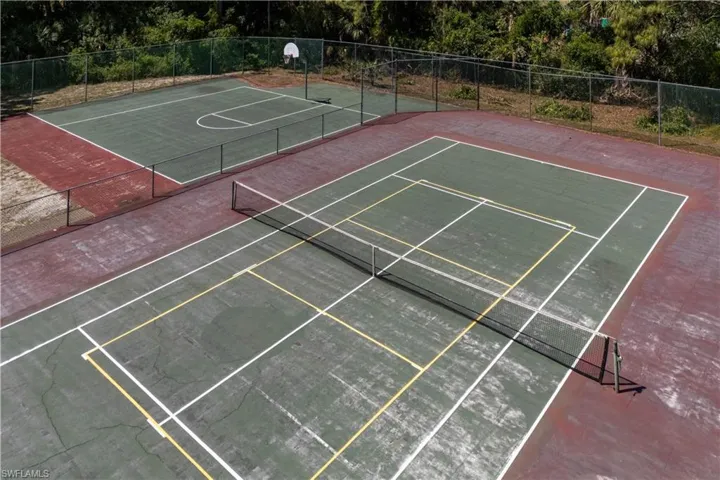 View of basketball court featuring fence and community basketball court