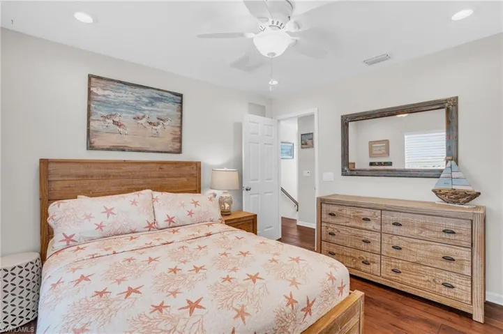 Bedroom with ceiling fan and dark hardwood / wood-style flooring