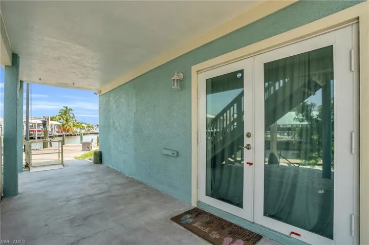View of exterior entry with a patio and french doors