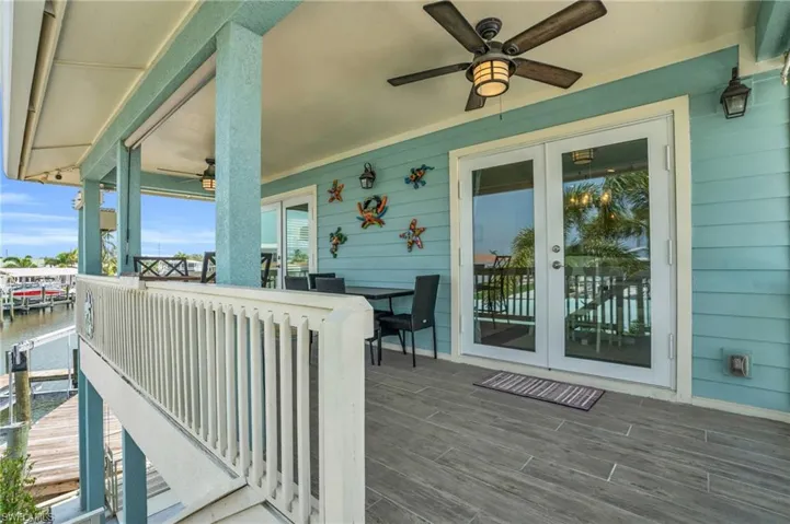 Wooden terrace with ceiling fan and french doors