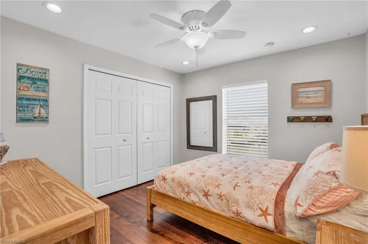 Bedroom featuring a closet, ceiling fan, and dark hardwood / wood-style floors