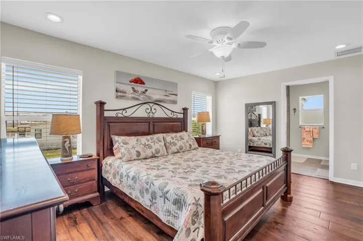 Bedroom with ceiling fan and dark hardwood / wood-style floors