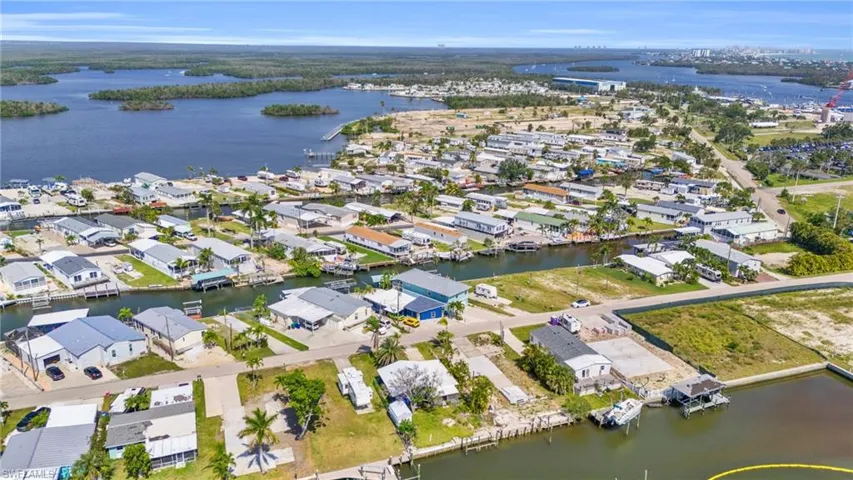 Birds eye view of property with a water view