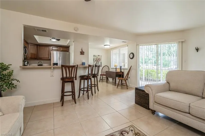 Living room featuring light tile floors