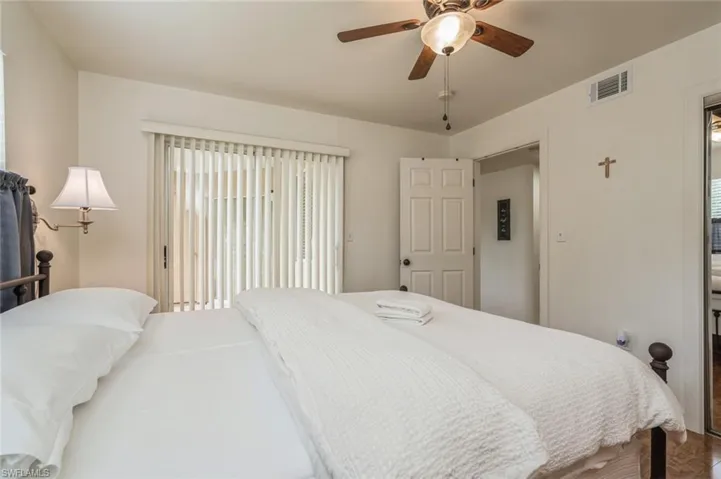 Bedroom featuring multiple windows and ceiling fan