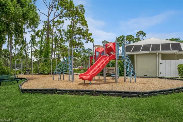 View of playground with a lawn