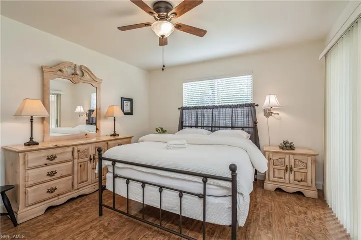 Bedroom featuring ceiling fan and dark hardwood / wood-style flooring