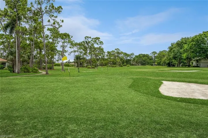 View of property's community with a yard