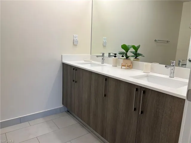Bathroom featuring tile patterned flooring and vanity