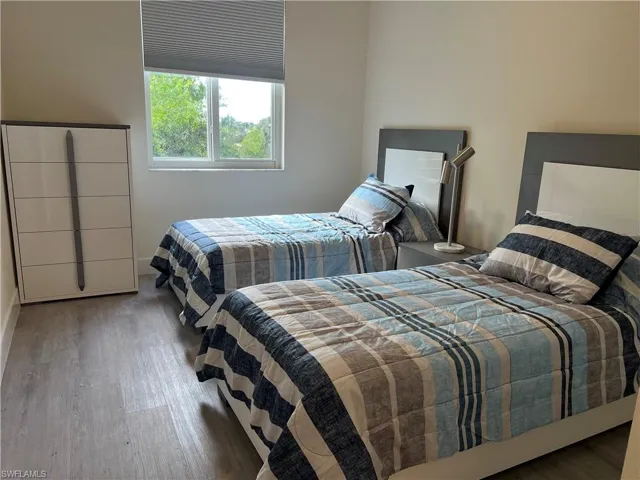 Bedroom with wood-type flooring