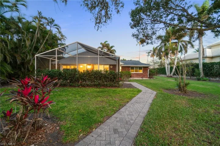 Yard at dusk with glass enclosure