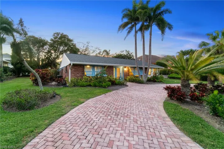 Location, location, location!  RARE and incredible potential to either rebuild or create your own luxury dream home! Single story existing Florida rancher  featuring paver driveway, brick facade exterior, expansive circular driveway and lush, tropical, mature, landscaping, shed in the rear, along with a residence second access road.