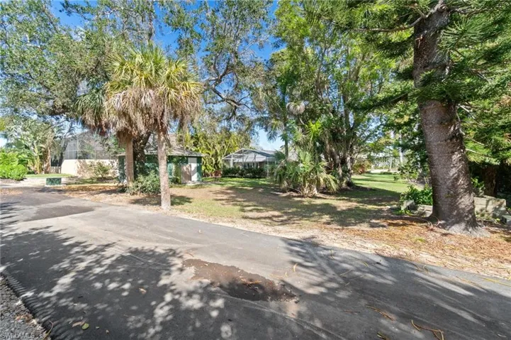 Rear view of property with 2nd ACCESS ROAD for a limited number of residents.  Rear existing detached garage structure.