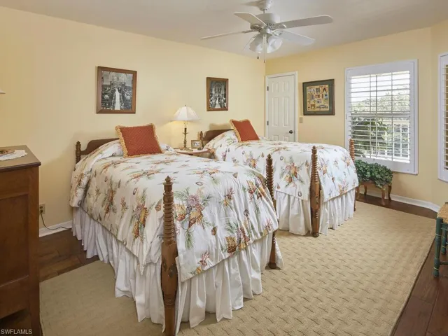 Bedroom with wood flooring, plantation shutters, nice size closet