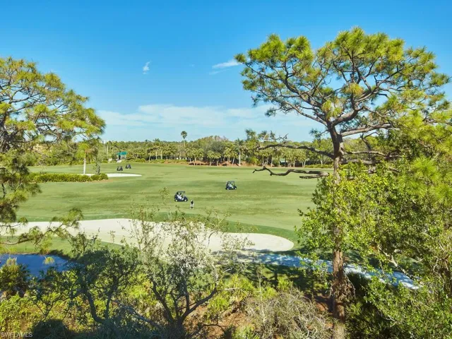 Surrounding community with a golf course double fairways and lush vegetation