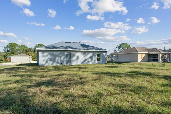 Back of property featuring a yard