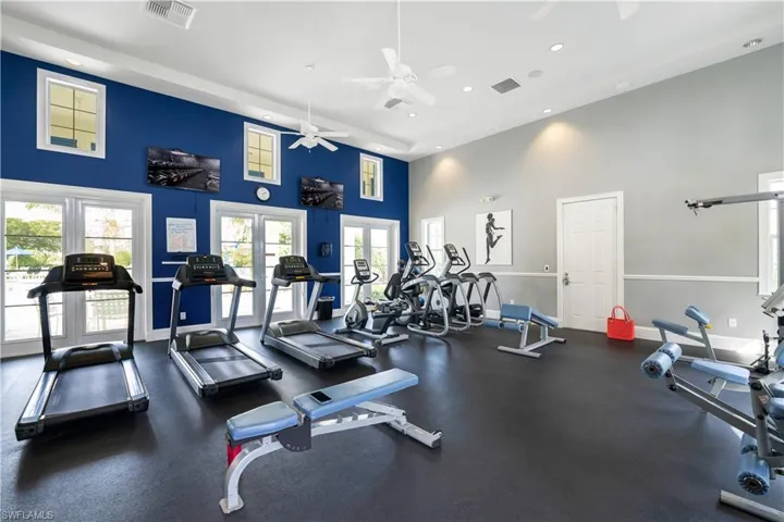 Gym featuring recessed lighting, baseboards, visible vents, and french doors
