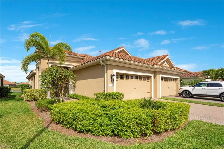 View of front of house with a tiled roof, decorative driveway, an attached garage, and stucco siding