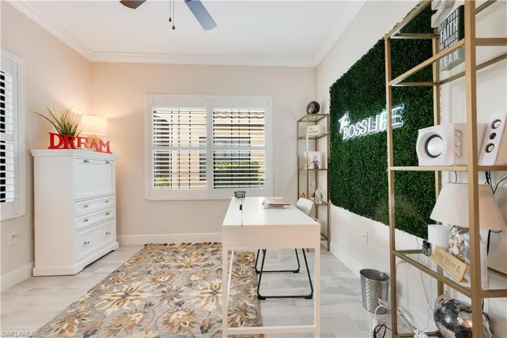 Office with ceiling fan, baseboards, and crown molding