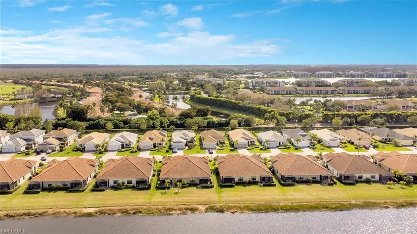 Drone / aerial view with a residential view and a water view