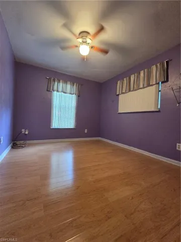 Kitchen featuring light wood-style flooring, white cab