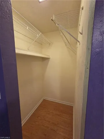 Master bedroom with wood finished floors and ceiling fan