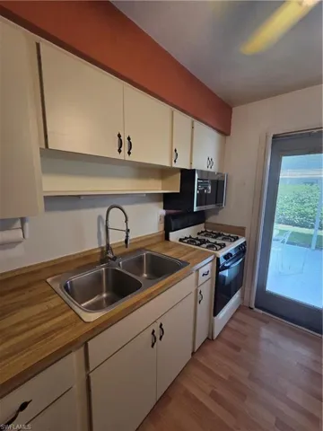 Entryway featuring light wood finished floors and baseboards with pull-screen privacy