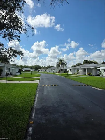 View of asphalt street featuring a residential view