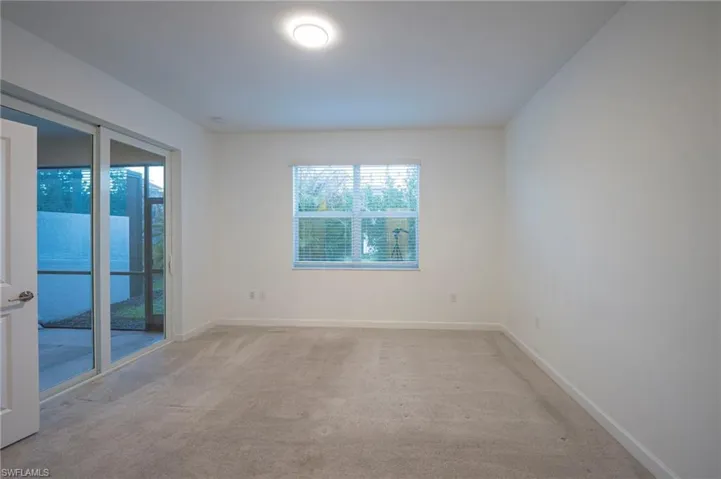 Empty room with light carpet and baseboards