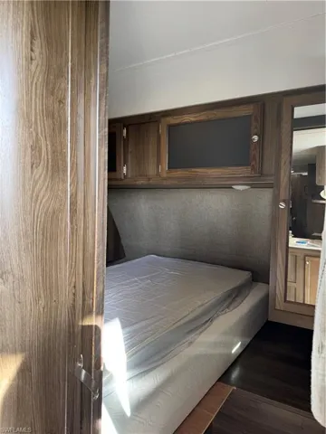 Bedroom with dark wood-type flooring