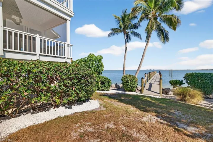 View of yard with a water view and a balcony