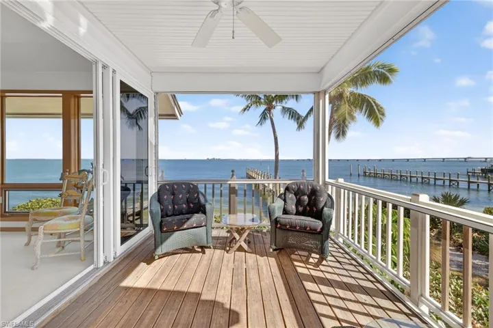 Deck featuring a water view and a ceiling fan