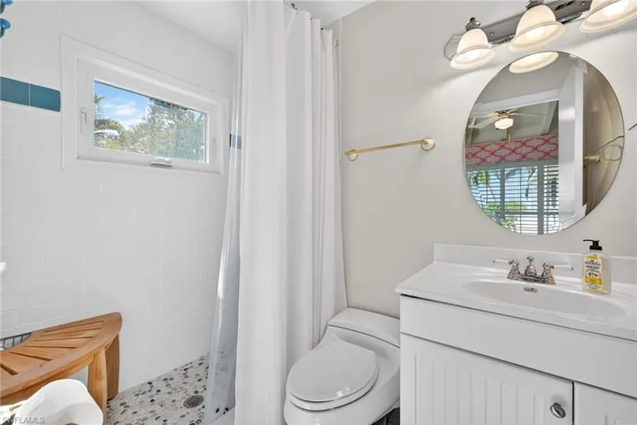 Bathroom featuring vanity and a tile shower